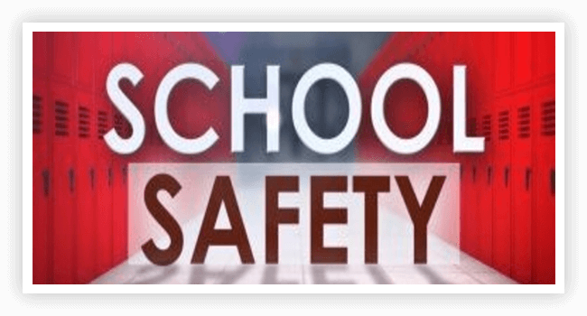 A red and white sign that says school safety.